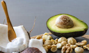 A close up of ketogenic food: coconut and coconut butter, avocado. walnuts and macadamia nuts